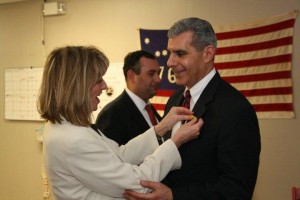 Bayshore Tea Party Group co-founder Barbara Gonzalez pinning Sen. Joe Kyrillos