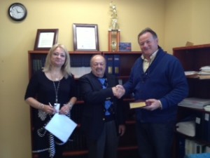 Warren Chamberlain, center, takes the oath of office as a Keyport Councilman.  Borough Clerk Valerie Valerie Heilweil, left, and Keyport GOP Chairman Bob Burlew, right.