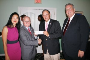 Assembly Minority Leader Jon Bramnick, center-right, presents a campaign contribution to Council candidate Sui Allex, Mayoral candidate Ira Goldberg and Council candidate John Dwyer at the Bella Vista Country Club last month