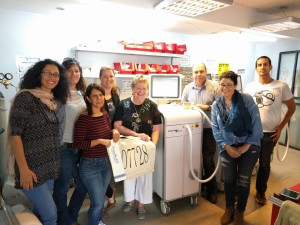 Israeli Ice-Cure Medial staff  with Muriel Smith at the cyroablation console, with one of the gifts Muriel brought for the staff to remind them where Centra State Medical Center is. Standing left to right: Maya Yurista- QA Manager, Odelya Eliyahu- Office Manager, Ravit Attali- Clinical Manager, Muriel, Gabriel Cohen- VP R&D Manager, Iris Firer- Accountant, Shahaf Yehuda -Production